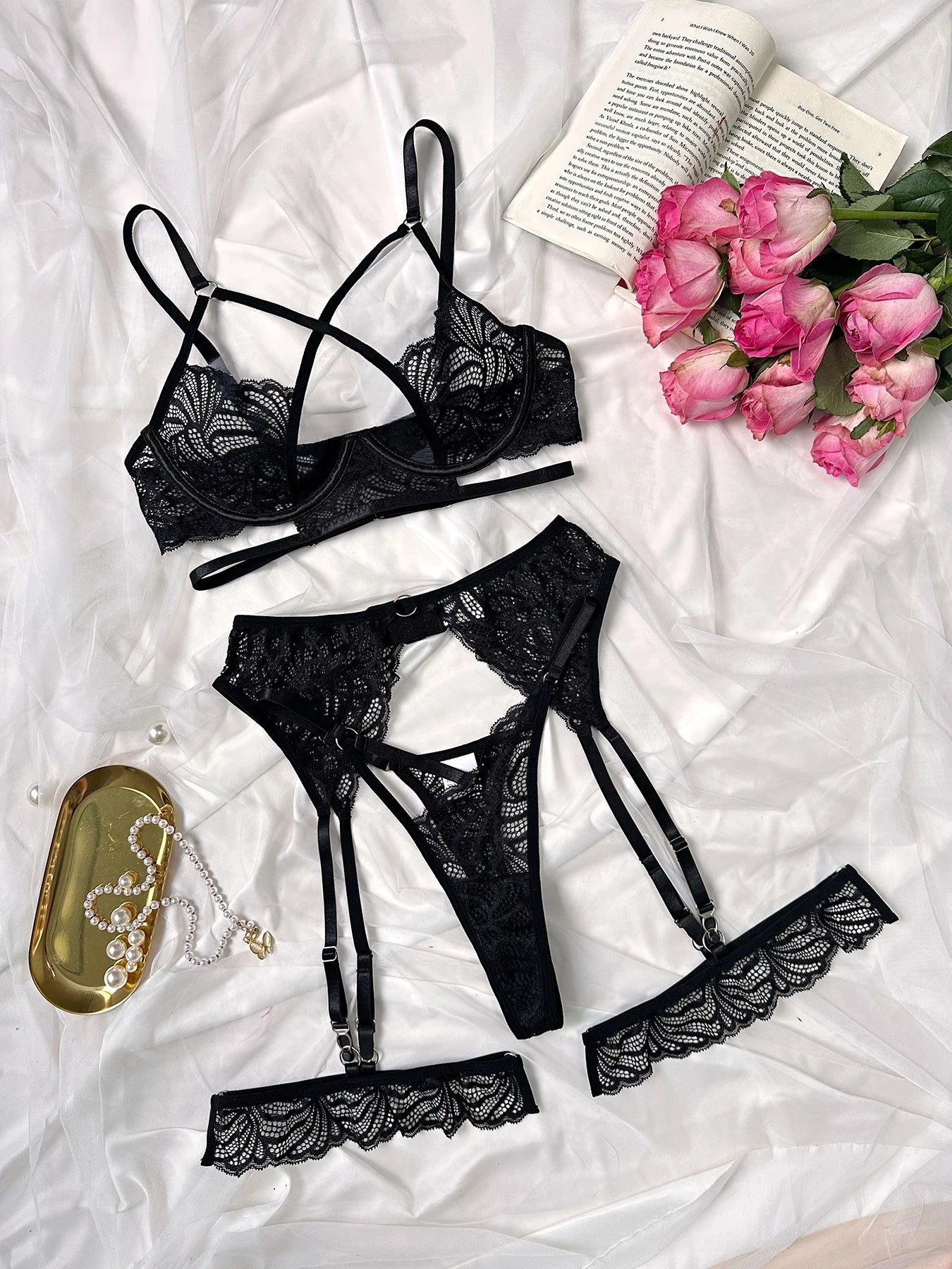 Elegant black lace lingerie set with strappy bra, garter belt and thong with floral details